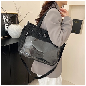 Detail of black transparent tote bag with heart rivets shown on grey blazer