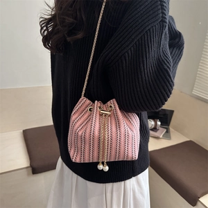 Pink woven tweed bucket bag with gold chain strap and pearl drawstring charms