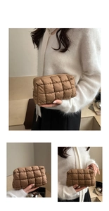 Macro view of dark brown quilted puffer makeup bag showing stitching and texture
