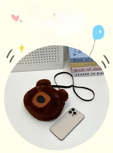 Brown plush bear crossbody bag size comparison shown next to a smartphone