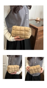 Detailed view of khaki quilted puffer makeup bag with soft stitched square texture
