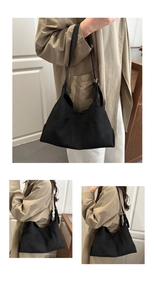 Detail view of a black suede hobo shoulder bag with matte finish and silver hardware accents