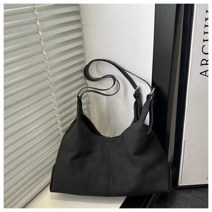 Detail shot of black matte tote bag showing its soft texture and large capacity