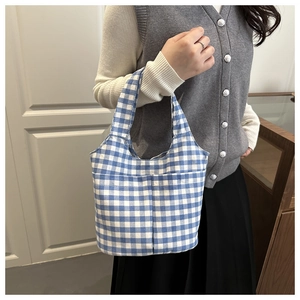 Detailed shot of blue and white gingham bucket bag with wide canvas handle for women