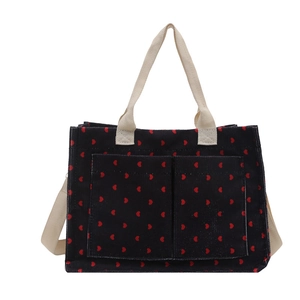 Navy corduroy tote bag with red heart pattern and cream cotton straps in a frontal view