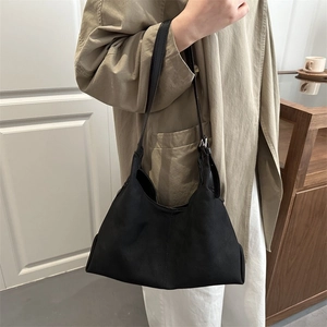 Minimalist large black suede tote bag for women showing a stylish shoulder wear style