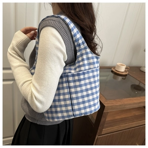 Detail shot of the side pocket on the blue and white gingham canvas bucket bag