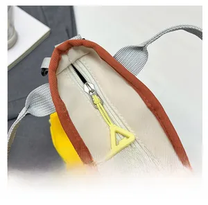 Detail of smooth white zipper with yellow triangular puller on tricolor canvas tote bag