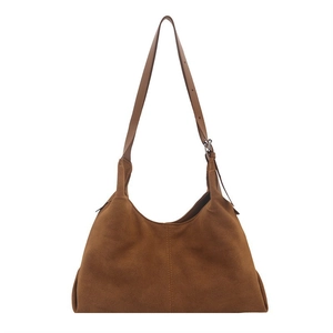 Caramel brown vintage suede tote bag with adjustable shoulder strap and center seam design