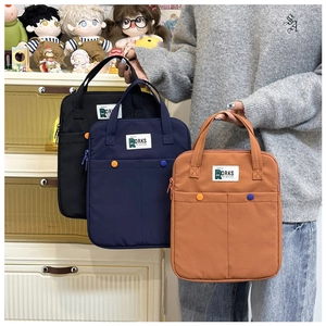 Trois housses d'ordinateur en nylon noir, bleu marine et orange avec poignées solides