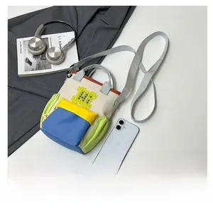Flat lay of a stylish multi-color crossbody phone bag with trendy fashion accessories