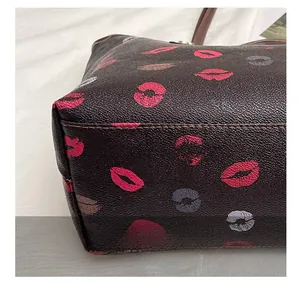 Detail showing the reinforced stitching and leather texture at the bottom of the tote bag