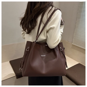 Dettaglio della borsa tote in ecopelle marrone scuro con anello in metallo e logo
