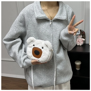 Close-up of white plush bear bag featuring faux fur texture and cute leather nose detail