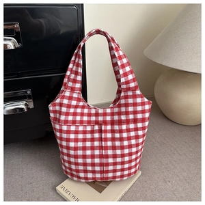 Detail of red gingham bucket bag with dual handles and functional front pocket