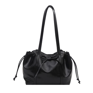 Glossy black leather tote bag with a delicate bow and drawstring ribbon details
