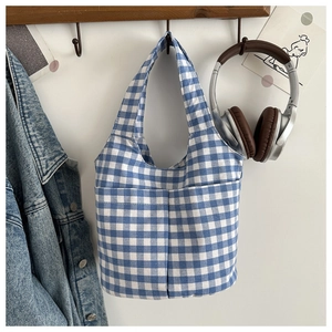Detailed blue and white checkered bucket bag with dual handles and symmetrical front pockets
