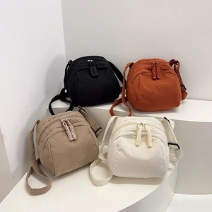 Minimalist corduroy shell bags for women shown in four versatile colors on a white pedestal