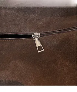 Close-up of brown pebbled leather texture with a polished silver metal zipper detail