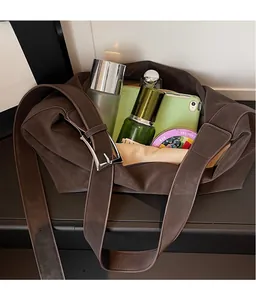 Macro detail of spacious interior storage in brown leather tote bag with silver buckle