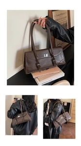 Close-up of vintage dark brown baguette bag with silver turn-lock and leather texture