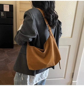 Brown wide strap hobo bag shown in a lifestyle shot for daily commute and styling