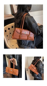 Detailed close-up of brown vintage shoulder bag with metal turn-lock and double strap design