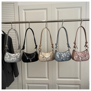 Detail of colorful half-moon handbags featuring letter prints and pearl chain charms