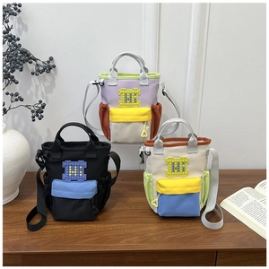 Three multi-color oxford crossbody bags featuring H-logo and adjustable nylon straps