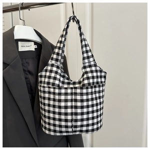 Close-up of black and white gingham canvas bucket bag with functional front dual pockets