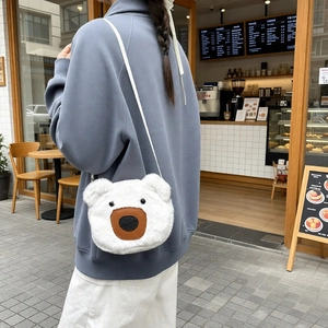 Cute white plush bear crossbody bag for women shown worn on a casual street style outfit