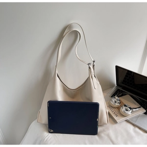 Minimalist off-white tote bag showing large capacity by placing a tablet inside