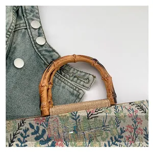 Detailed close-up of natural bamboo handle and floral jacquard tote bag with retro style