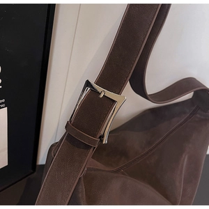 Close-up of the vintage brown faux leather strap with silver metal buckle detail