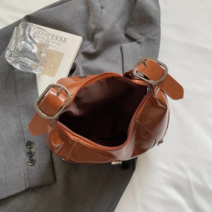 Retro caramel crescent shoulder bag with silver buckle and spacious interior compartment
