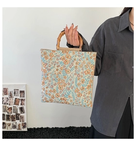 Detailed close-up of a square floral jacquard tote bag with authentic bamboo handles