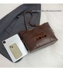 Brown tote bag size comparison with smartphone and iPad showing large interior capacity