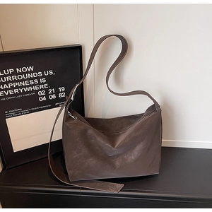 Detail view of the soft vintage dark brown matte leather shoulder bag with adjustable strap