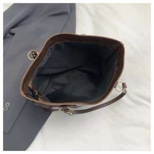 Top view of deep brown tote bag showing large interior capacity and gold ring hardware