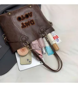Interior view of brown tote bag showing capacity for tablet, umbrella and makeup