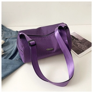 Detailed shot of a purple plaid bucket bag with adjustable strap and metal logo plate