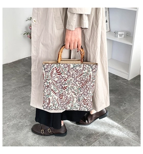 Detail of vintage floral tapestry fabric and natural bamboo handles on the tote bag
