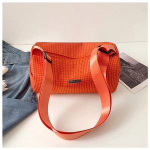 Detail of orange plaid nylon bucket bag with adjustable strap and metal label