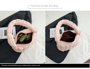 Detail view showing the spacious interior compartment of this pink quilted cotton bag