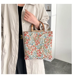 Close-up of vintage floral jacquard fabric and natural bamboo handles on tote bag