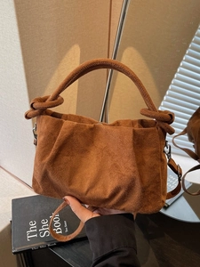 Brown suede ruched cloud bag with knotted handle and detachable crossbody strap