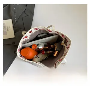 Top view showing the spacious interior of a white tote bag with red cherry prints