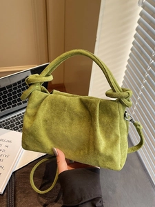 Lime green pleated cloud bag with suede texture and decorative knot handle design