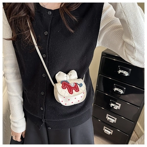 Close-up of a white mini crossbody bag with red pony embroidery and heart pattern