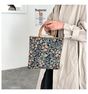 Detail of floral tapestry fabric with vintage bamboo handle on a large tote bag